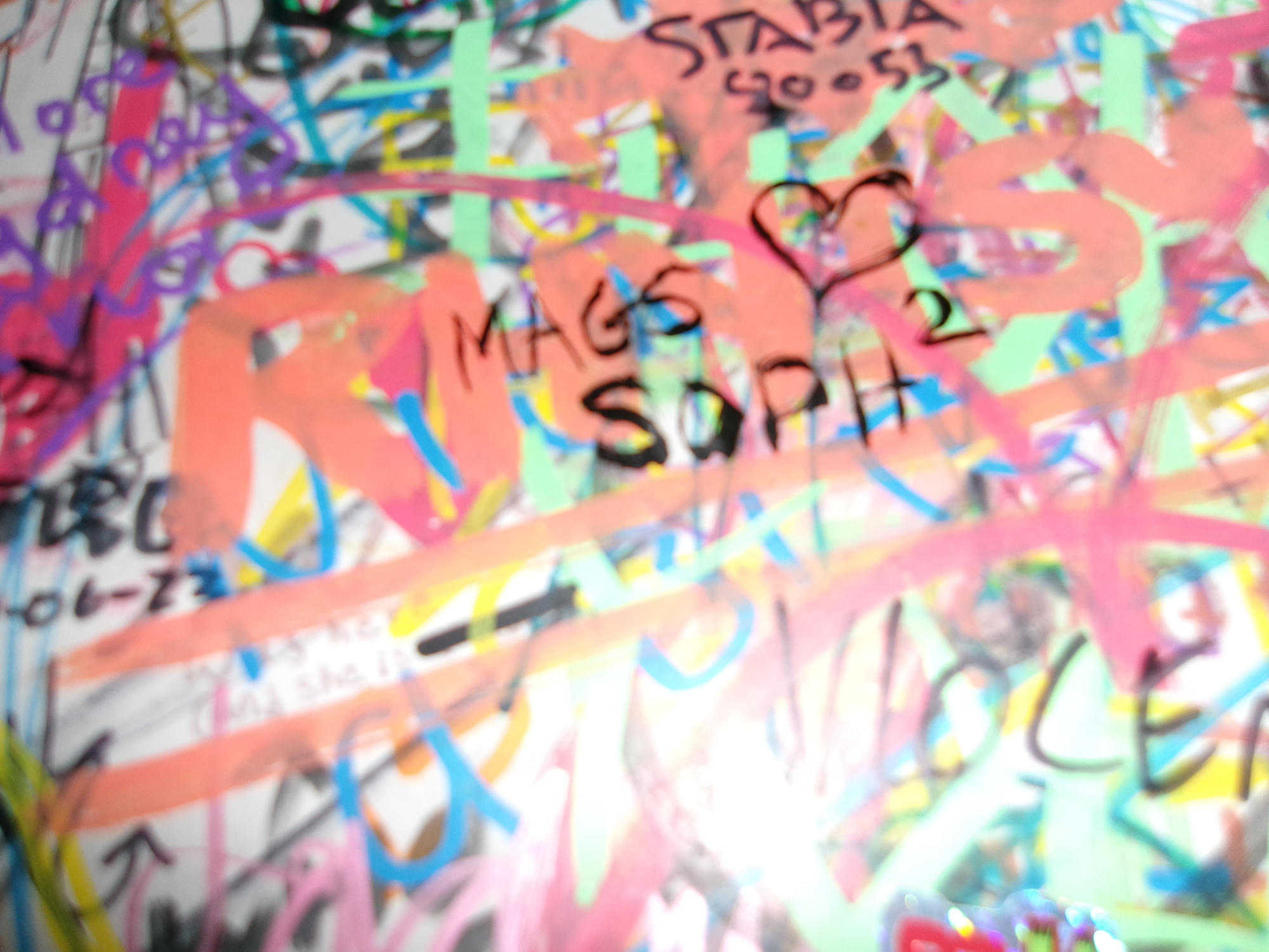 Colorful layered street art with a hand-drawn heart.