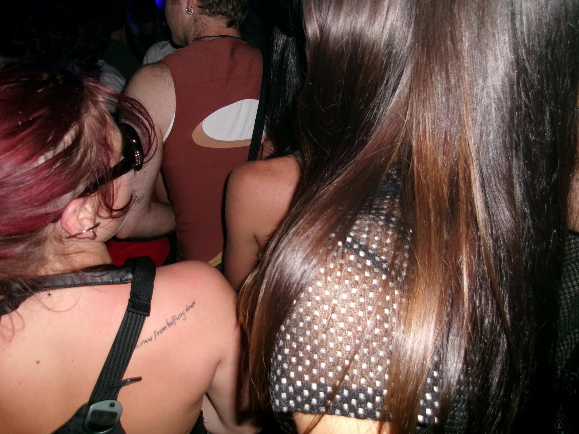A close view of people in a concert crowd.